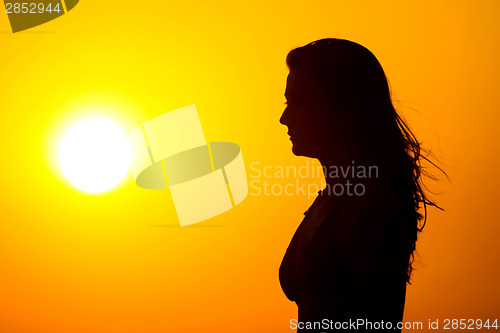 Image of Woman watching sunset