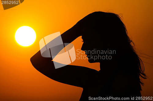 Image of Woman silhouette on sunset
