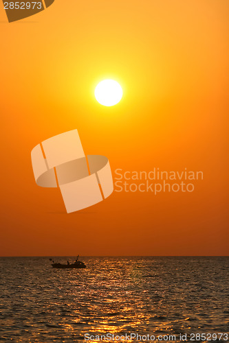 Image of Boat sailing at sunset