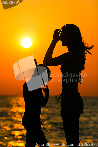 Image of Silhouette of people at sunset