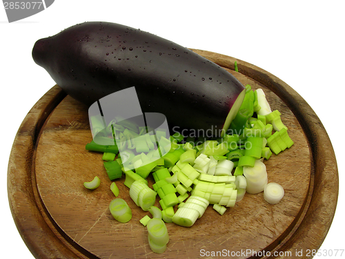 Image of Eggplant and cutted  spring onion on wooden plate 