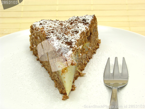 Image of One slice of pear cake on a white plate dusted with powder sugar