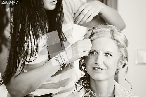 Image of hair stylist designer making hairstyle for woman