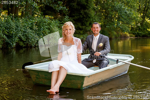 Image of Young just married bride and groom on boat