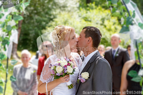 Image of beautiful young wedding couple kissing