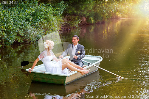 Image of Young just married bride and groom on boat