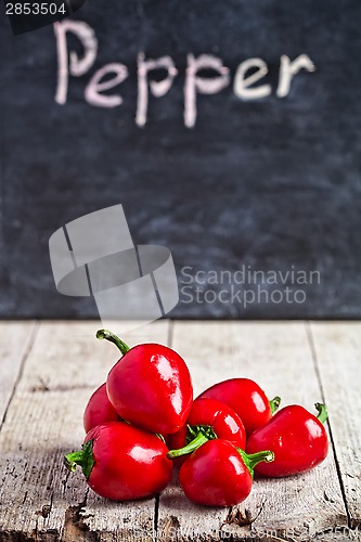 Image of red hot peppers and blackboard