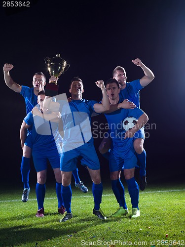 Image of soccer players celebrating victory