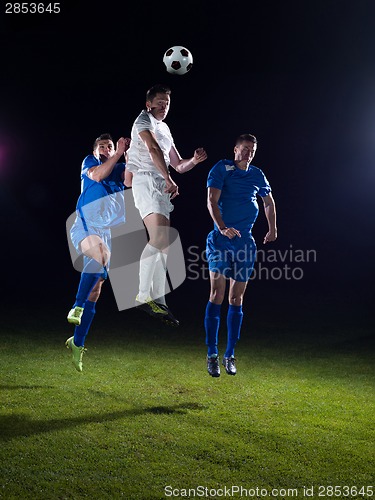 Image of soccer players duel