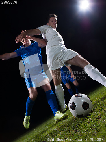 Image of soccer players duel