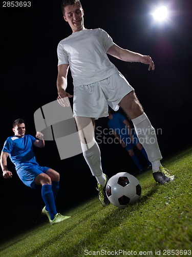 Image of soccer players duel