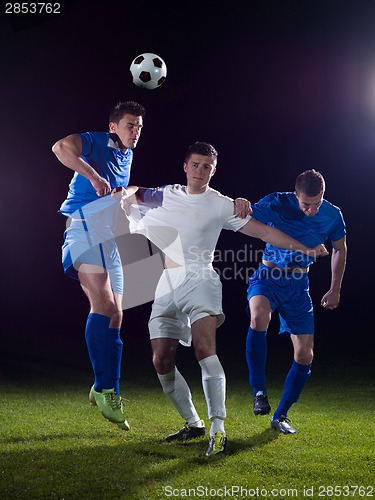 Image of soccer players duel