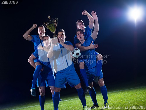 Image of soccer players celebrating victory