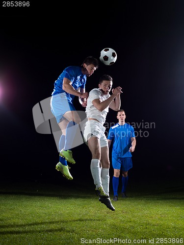 Image of soccer players duel