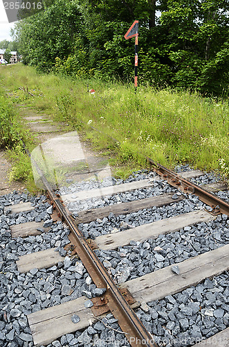 Image of old rusty rails, sleepers and grass