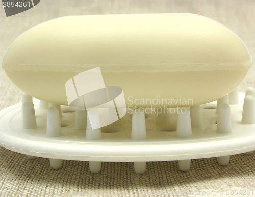 Image of Beige soap on a soap dish on a beige background