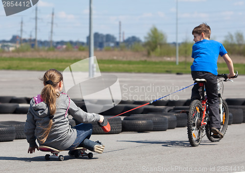 Image of Cyclist and skateboarder