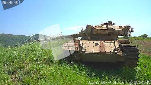 Image of Destroyed rusty tank on battlefield near the border