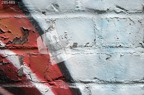 Image of Graffiti on a peeling brick wall