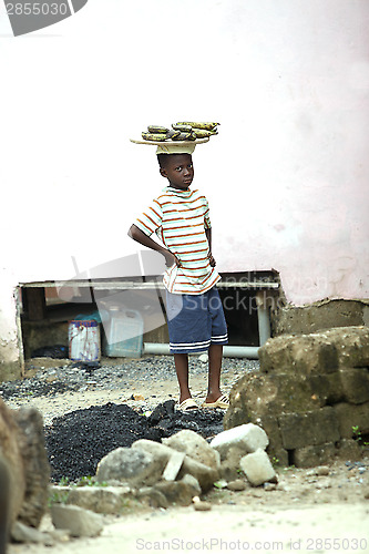 Image of Portrait of an african boy wearing bananas on his head