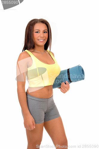 Image of Teen girl with yoga matt.