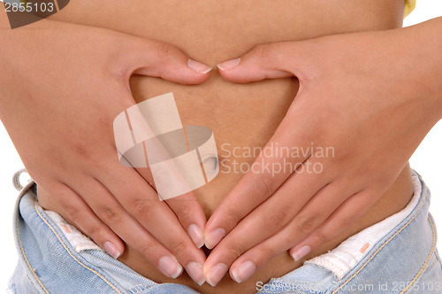 Image of Woman holding hands on stomach.