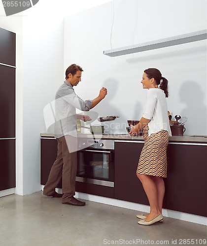 Image of Young couple working in kitchen