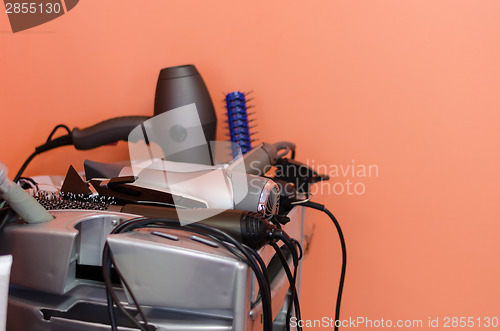 Image of hairdressers accessories lie neatly on shelf 