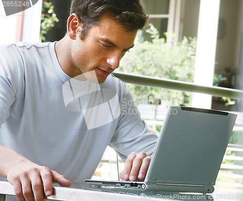 Image of man is working on laptop computer