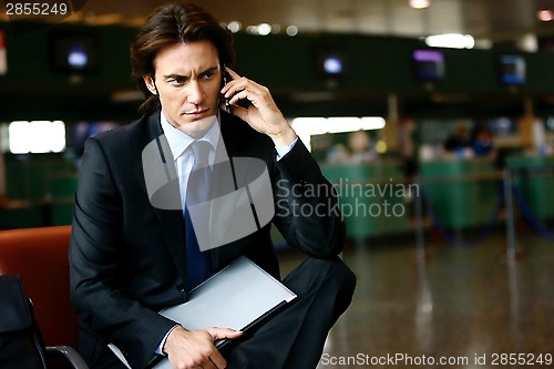 Image of businessman in the airport mobile l