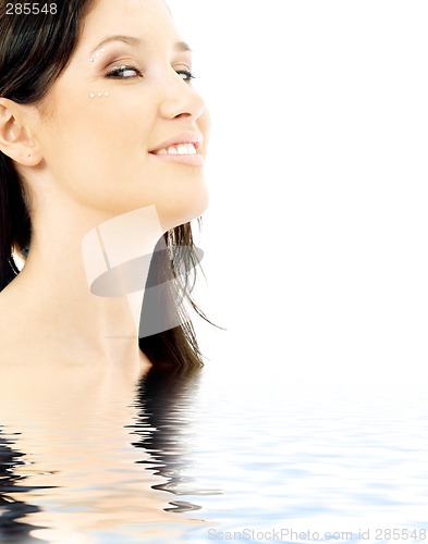 Image of smiling brunette with diamond make-up in water