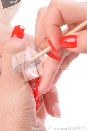 Image of manicure applying - cleaning the cuticles 