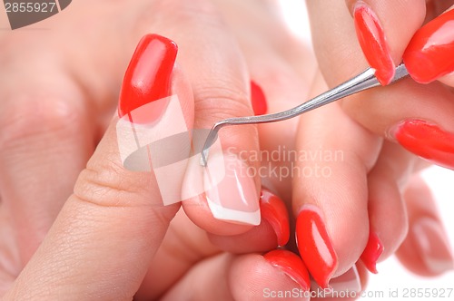 Image of manicure applying - cleaning the cuticles 