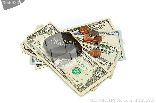 Image of charity stone with money over white