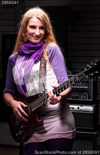 Image of Attractive woman with  electric guitar