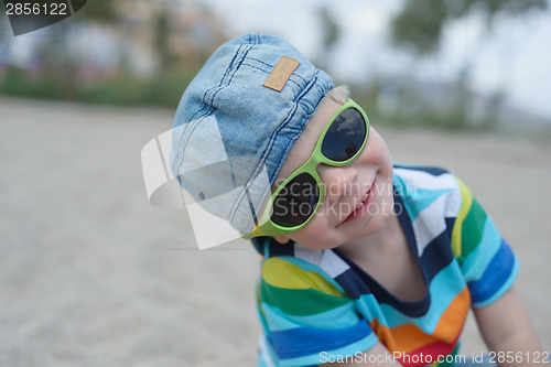Image of Cute boy in denim hat and sunglasses