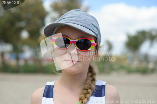 Image of Girl in denim hat and sunglasses