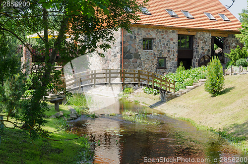 Image of park with bridge over stream ancient brick manor 