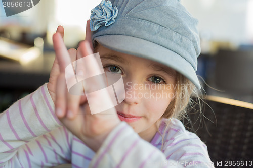 Image of Cute girl showing horn signs
