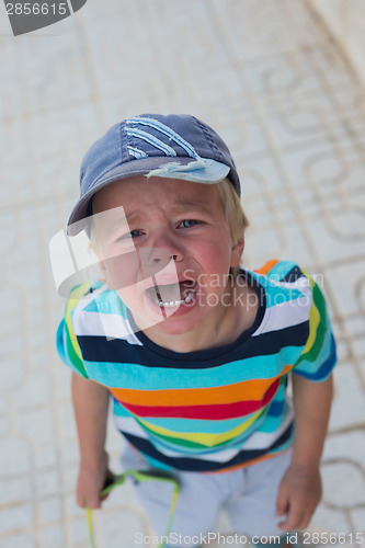 Image of Crying boy standing on the street
