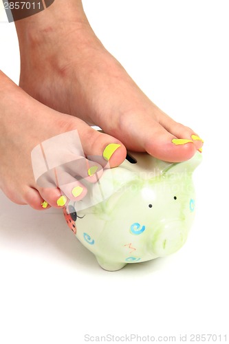 Image of pedicure and coin pig