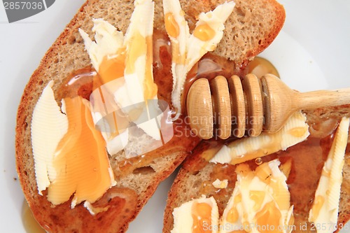 Image of bread, butter and fresh honey 