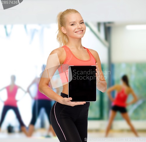 Image of smiling woman showing tablet pc blank screen