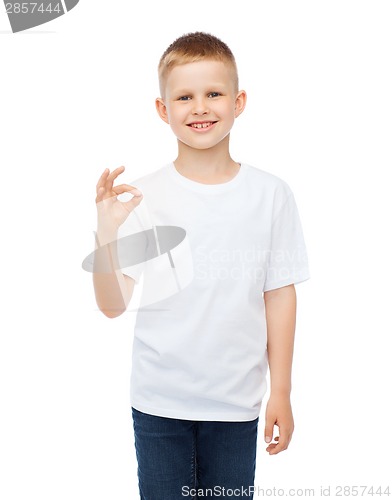 Image of little boy in white t-shirt showing ok gesture