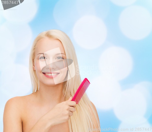 Image of smiling woman with hair brush