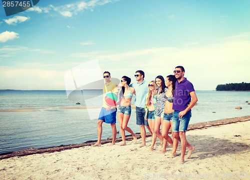 Image of group of friends having fun on the beach