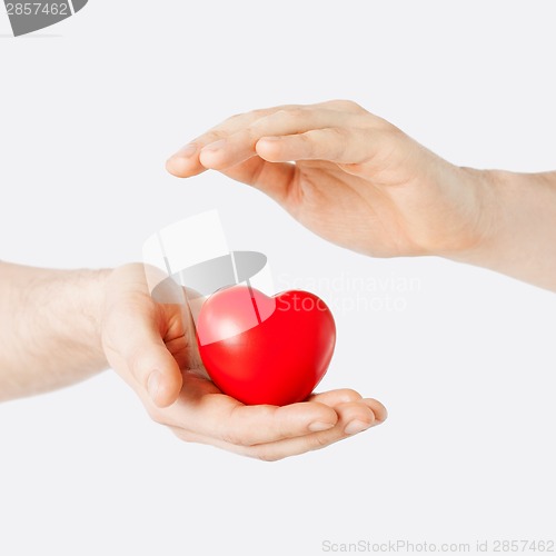 Image of male hands with small red heart