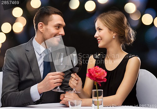 Image of young couple with glasses of wine at restaurant