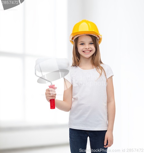 Image of smiling little girl in helmet with paint roller