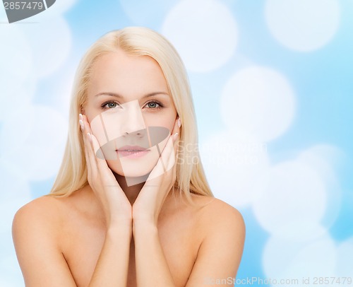 Image of beautiful woman touching her face skin